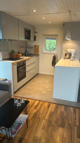 a kitchen with a table and a counter top at Strandstugan in Halmstad