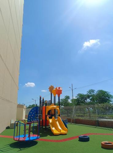 a playground with a slide in a park at Lajoya in Barranquilla