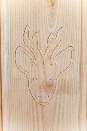 a wooden table with a drawing of a deer head on it at Magnifique chalet à 3km PEYRAGUDES PYRENEES LUCHON in Gouaux-de-Larboust
