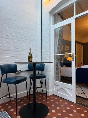 a room with a table and two chairs and a window at The Garden Flat - Newly Refurbished Throughout in Dorchester