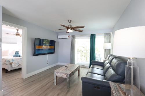 a living room with a couch and a ceiling fan at The Inn on Siesta Key in Siesta Key