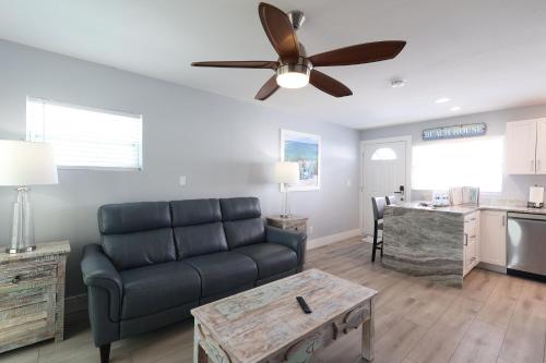 a living room with a couch and a ceiling fan at The Inn on Siesta Key in Siesta Key