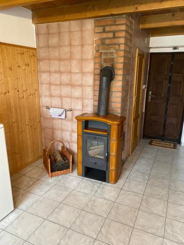 a wood stove in a room with a door at Rekreační chata in Hodonín