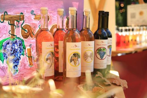 a group of wine bottles sitting on a table at Tazos Winery guest house in Abasha