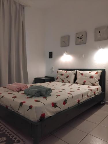 a bedroom with a bed with flowers on it at Angelo's Apt in Mesochórion