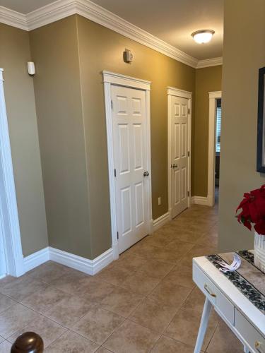 a living room with green walls and tile floors at 4- Bedroom Modern Townhouse in Halifax