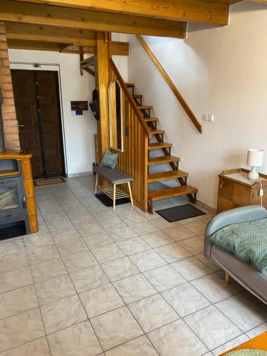 a living room with a staircase and a couch at Rekreační chata in Hodonín