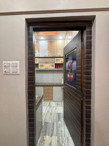 a door into a kitchen with a tile floor at DeeHa Niwas - A Banarasi Home in Varanasi