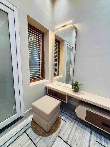 a bathroom with a stool and a mirror at DeeHa Niwas - A Banarasi Home in Varanasi