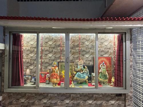 a window with a bunch of statues in it at DeeHa Niwas - A Banarasi Home in Varanasi