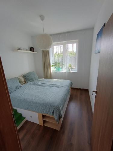 a small bedroom with a bed and a window at Maison de Veve in Svätý Michal