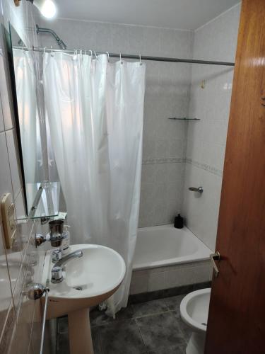 a bathroom with a sink and a toilet and a shower at Dpto Saavedra Santa Fe in Santa Fe