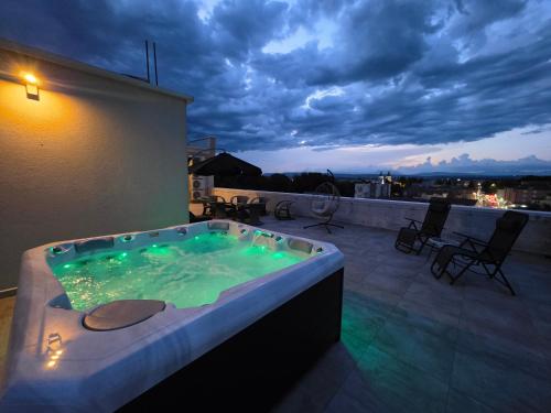 a jacuzzi tub on the roof of a house at Penthouse Olivia Međugorje - Private Jacuzzi in Međugorje