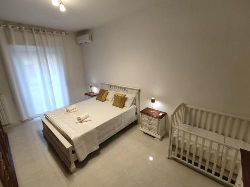 a bedroom with a bed and a baby crib at HOME SWEET HOME Casa vacanze e affitti brevi in Trani