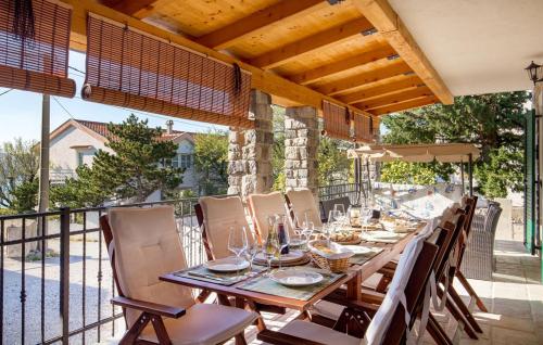 a wooden table on a balcony with chairs at VILLA MATIJA in Cesarica