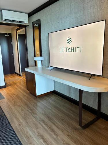 a desk with a screen on top of it at Matavai View - Premium Oceanfront Suite in Arue