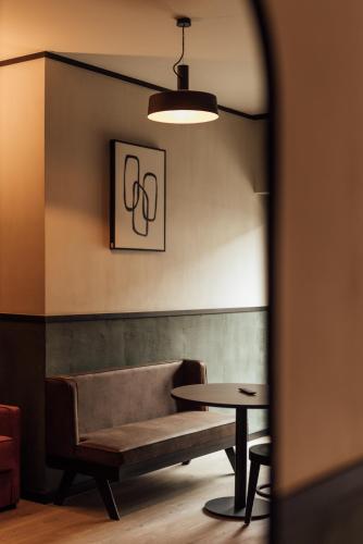 a couch and a table in a room at Getaway Studios Liège in Liège