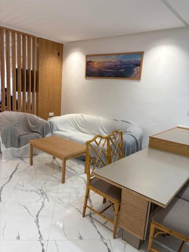 a living room with a couch and a table at apparemment sea view 01 in Tangier