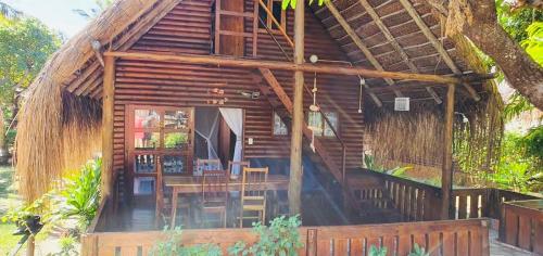 a cabin with a table and chairs in front of it at Viva O Sonho 