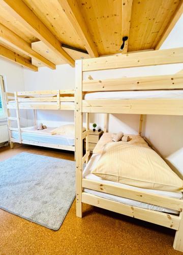 two bunk beds in a room with a wooden ceiling at Ferienwohnung Südtor in Geisingen