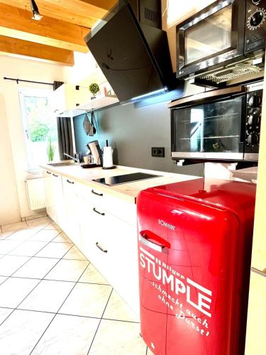 a kitchen with a red trash can in a kitchen at Ferienwohnung Südtor in Geisingen