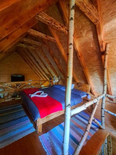 a bed in the attic of a wooden cabin at Kuca za odmor in Vitez