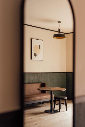 a table and a bench in a room at Getaway Studios Liège in Liège