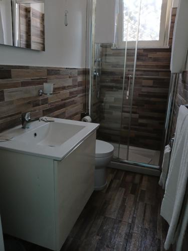 a bathroom with a sink and a toilet and a shower at Maison Martina in Giardini Naxos