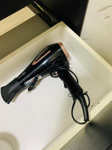 a hair dryer in a white box at kitnet dos Sonhos in Florianópolis
