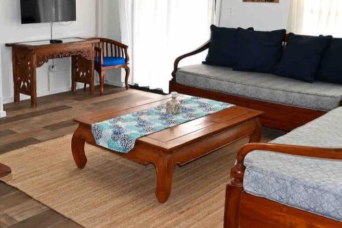 a living room with a couch and a coffee table at Hummingbird Villa in Saint Johnʼs