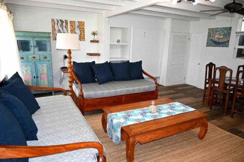 a living room with a couch and a coffee table at Hummingbird Villa in Saint Johnʼs