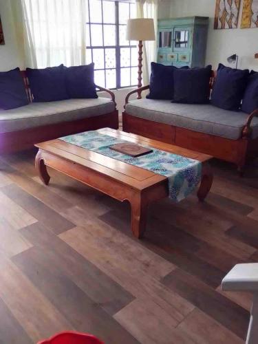 a living room with couches and a coffee table at Hummingbird Villa in Saint Johnʼs