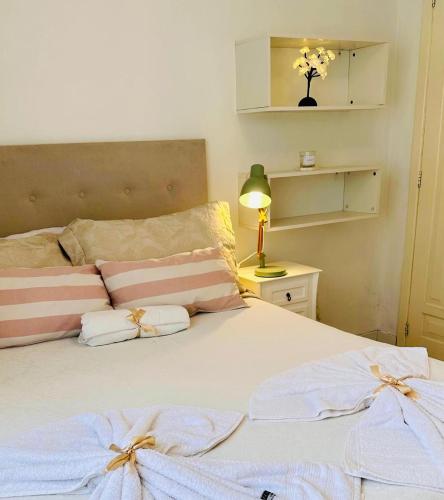 a bedroom with a bed with two pillows on it at kitnet dos Sonhos in Florianópolis