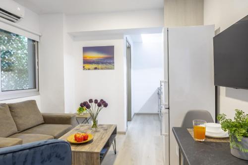 a living room with a couch and a table at C-premium Apts 100m From Beach And City Centre in Larnaka