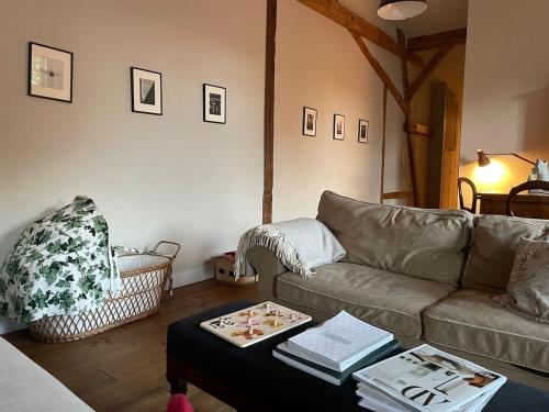 a living room with a couch and a table at Stylish Loft Apartment on a Country Farm in Bad Fallingbostel