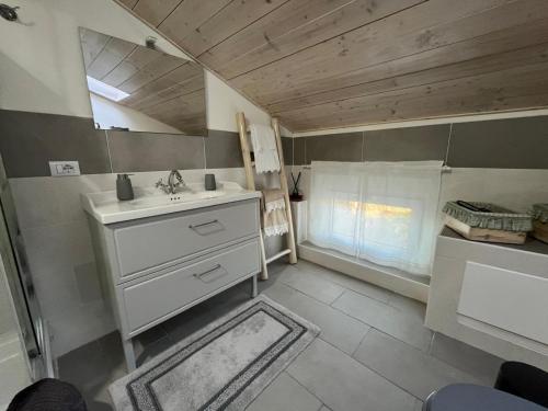 a small bathroom with a sink and a window at Lucciano Suite in Quarrata