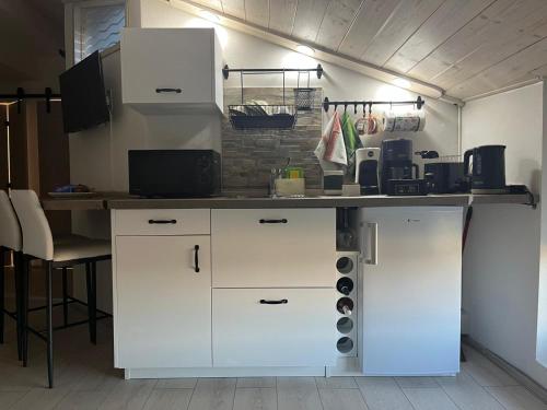 a kitchen with white cabinets and a counter top at Lucciano Suite in Quarrata
