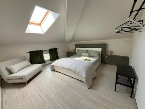 a bedroom with a bed and a chair and a window at Lucciano Suite in Quarrata