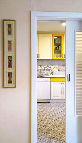 a kitchen with yellow cabinets and a sink at ZNK Family House in Skopje