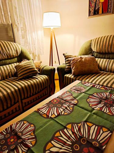 a living room with a couch and a blanket at ZNK Family House in Skopje