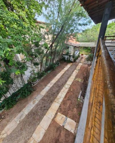 a backyard with a stone walkway and a fence at Capitólio 05 Hospedagem em Canoa Quebrada Ce in Canoa Quebrada