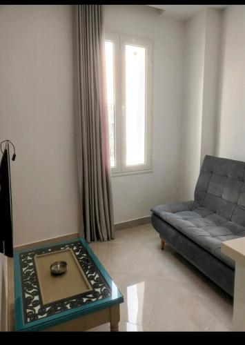 a living room with a couch and a table at Dar Maram Tunis in Tunis