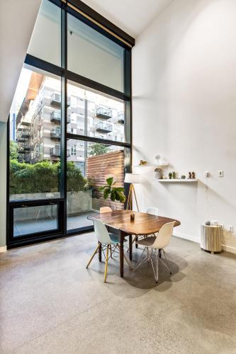 a dining room with a wooden table and chairs at Open Loft in Redmond Core - 92 Walkscore! in Redmond