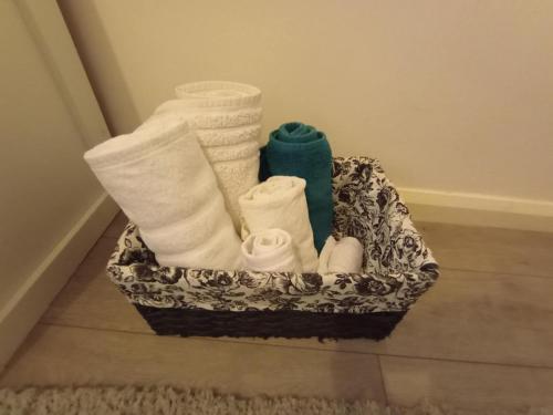 a basket filled with towels and socks on a floor at The Paddock Side in Uttoxeter