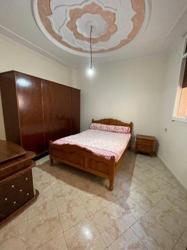 a bedroom with a bed and a ceiling at Little spot in Al Hoceïma