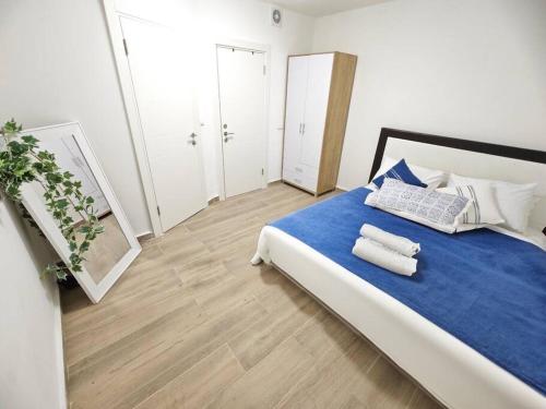 a bedroom with a large bed with blue sheets and pillows at קסם הכנרת in Tiberias