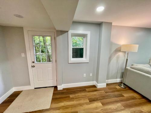 an empty living room with a door and a window at Oak House in Silver Spring