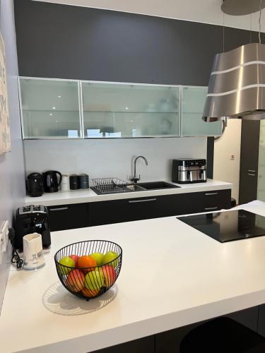 a kitchen with a bowl of fruit on a counter at Beachside - Stunning sea view townhouse across the road from the beach in Kilkeel