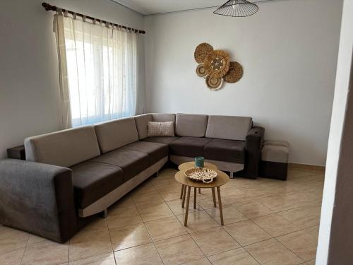 a living room with a couch and a table at Boho Apartment Himara in Himare