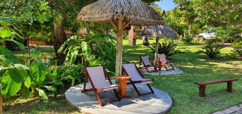 a group of chairs and an umbrella and a bench at Viva O Sonho 